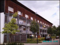 Wohnhaus mit Holzfassade und Balkonen